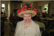 Woman Wearing Hat with Red Flowers