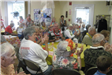 Group Sitting at Yellow Table Clapping