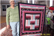 Woman Holding Black and Red Quilt