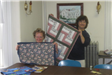 Two Women Holding Quilts
