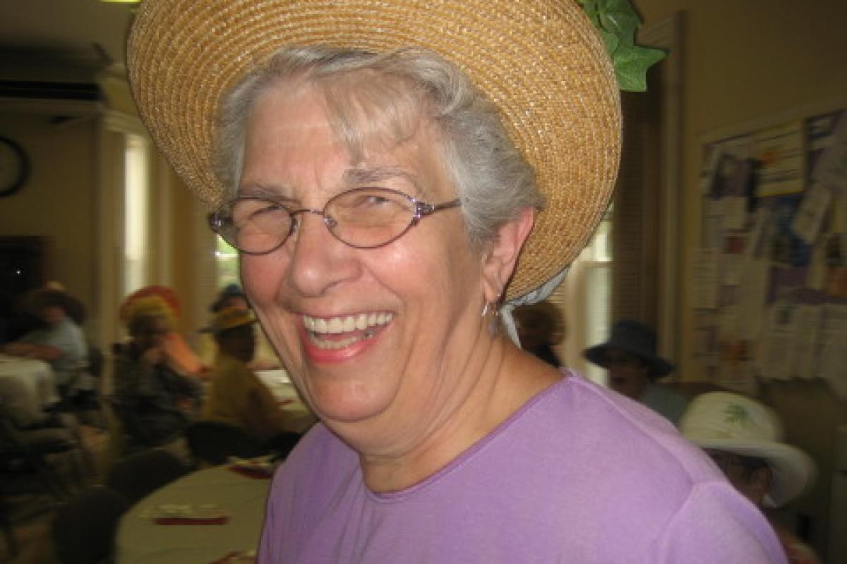 Woman Smiling and Wearing Yellow Hat