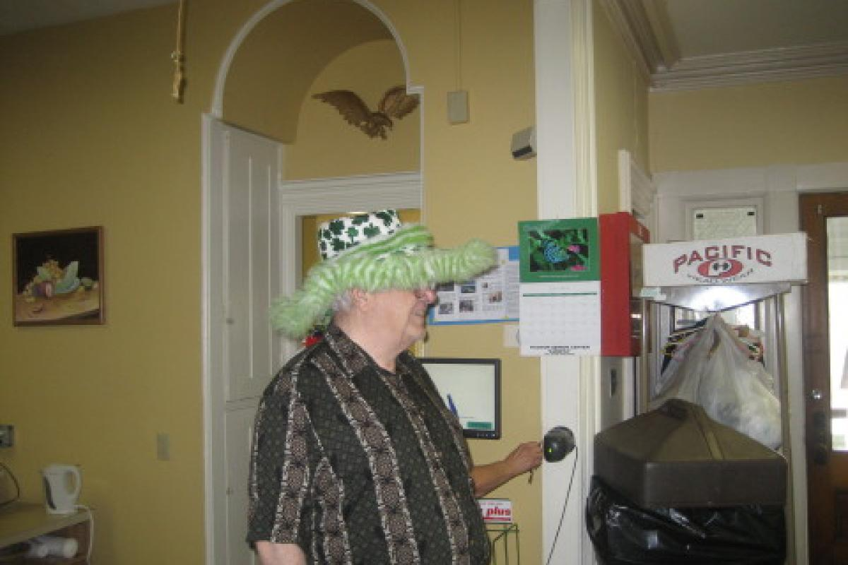 Man Wearing Green Fuzzy Hat