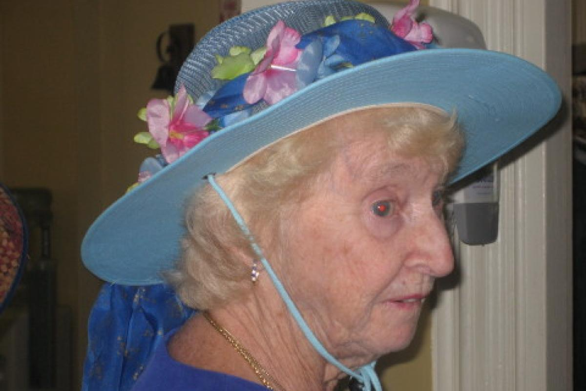 Woman Wearing Blue Hat with Flowers