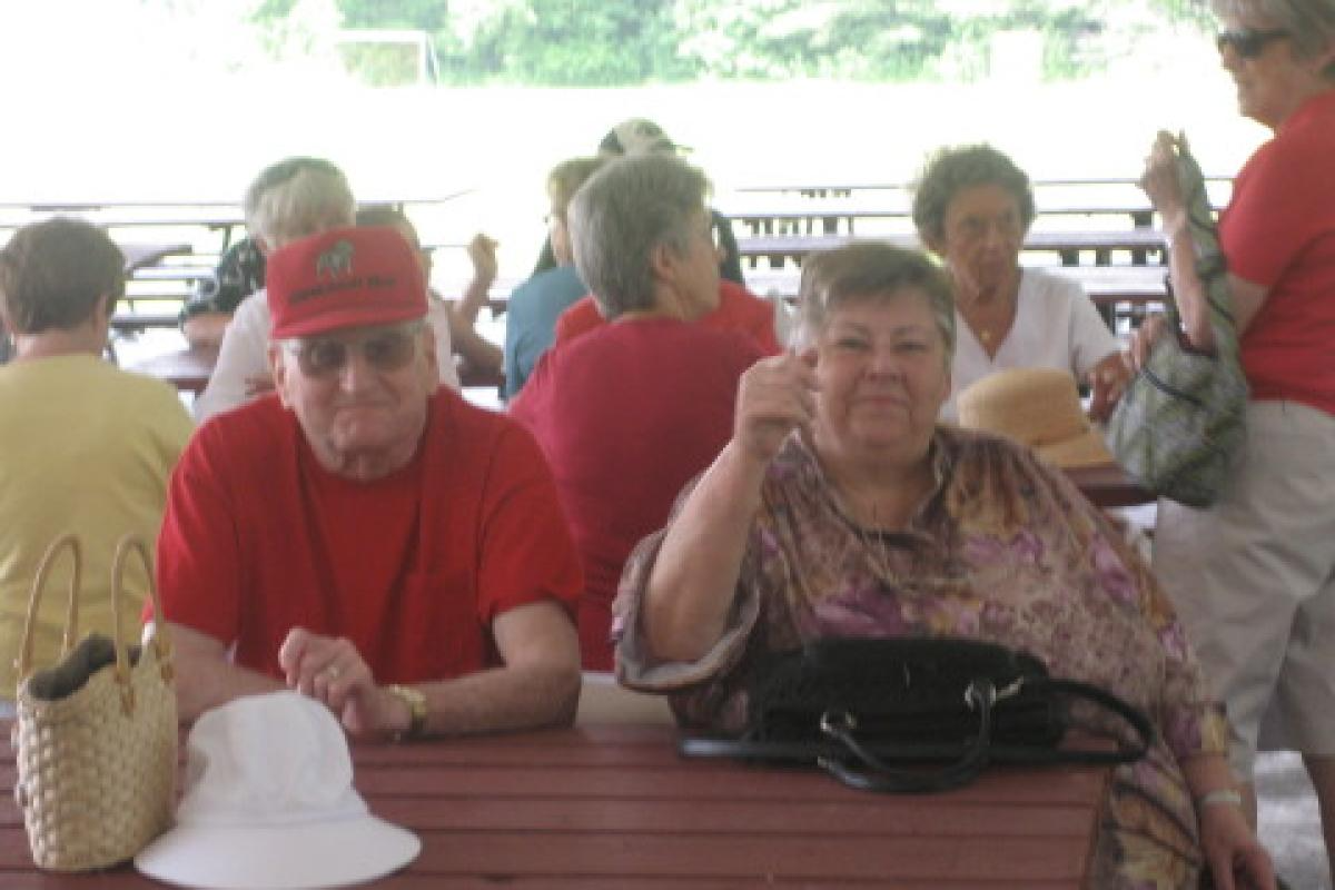 Senior Man and Woman Sitting at Picnic Table