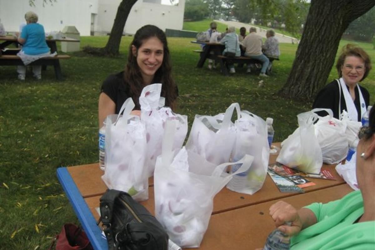 People Sitting with Lunch Bags