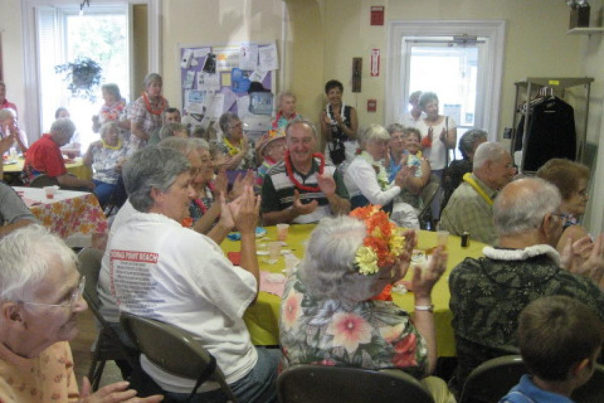 Group Sitting at Yellow Table Clapping