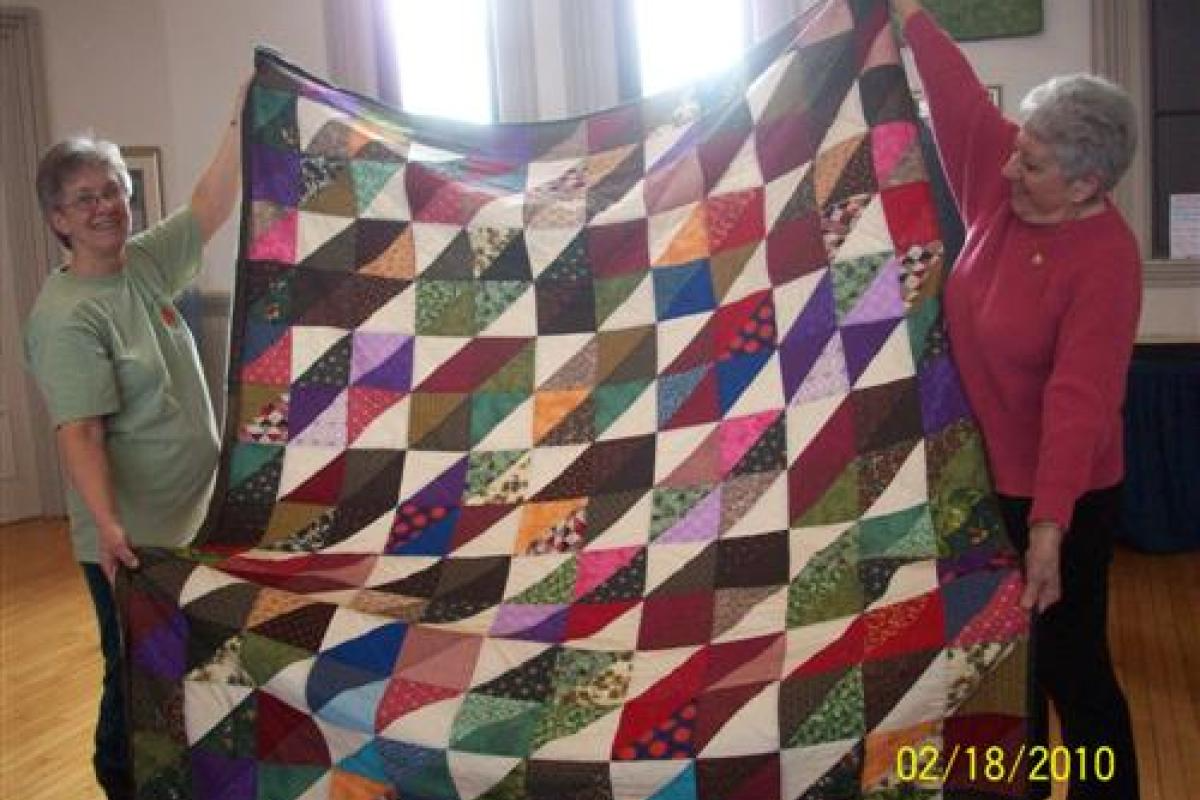 Woman Holding Multicolor Quilt