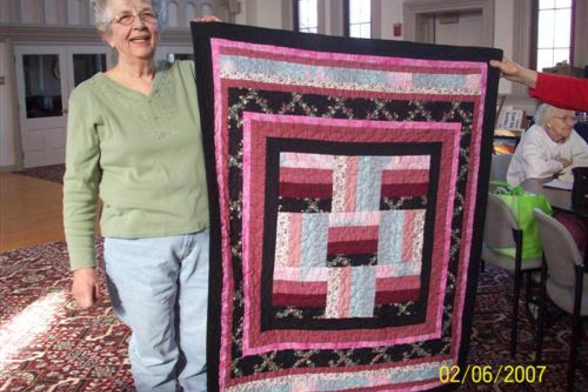 Woman Holding Black and Red Quilt